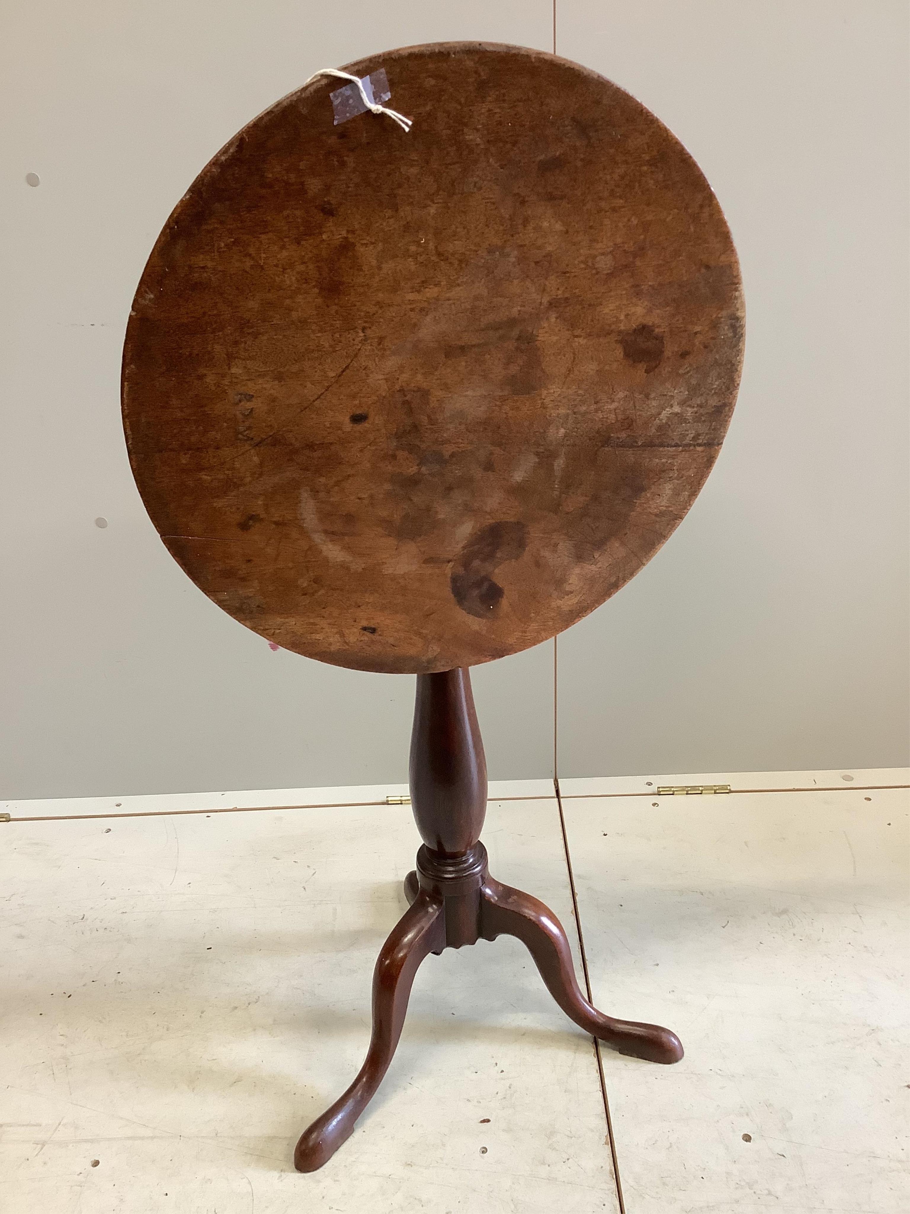 An early Victorian mahogany tilt top tripod wine table, diameter 51cm, height 71cm. Condition - fair